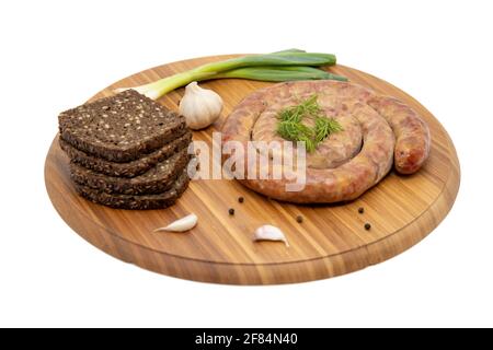 Salsiccia di cumberland avvolta con tavola rustica all'aglio Foto Stock