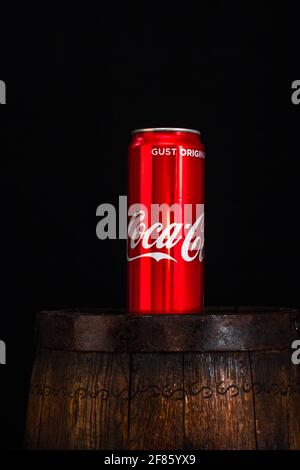 BUCAREST, ROMANIA - Mar 29, 2021: Lattina di Coca Cola su barile di legno con sfondo scuro. Foto editoriale illustrativa Bucarest, Romania, 2021 Foto Stock