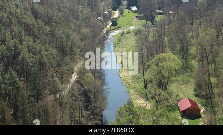 Vista sulla valle con fiume e piccola colonia dalla cima della roccia Foto Stock