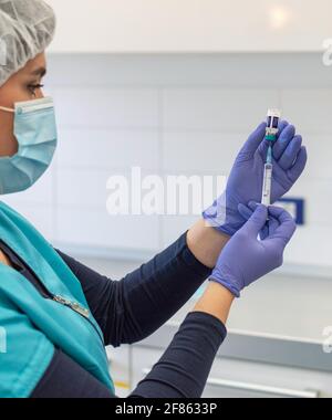 Vista laterale della siringa contenente il medico e del flaconcino di vaccino. Covid, Coronavirus, vaccinazione. Foto Stock