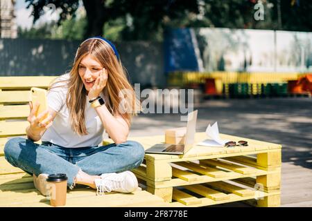 Donna in cuffia che ha una videochiamata. Foto Stock