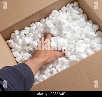 Una scatola di cartone con imballo di pellet di schiuma di styro vista dall'alto Foto Stock