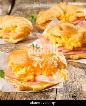 Prosciutto e formaggio uovo Sandwich colazione su un cornetto Foto Stock