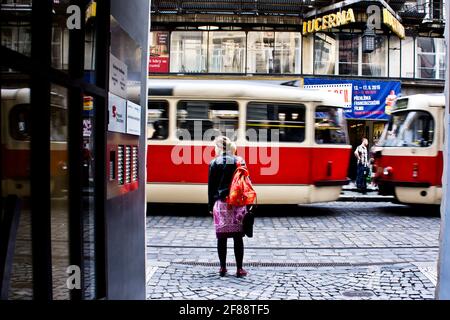 Giovane donna in attesa di attraversare via Vodickova a Praga Foto Stock