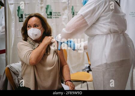 Caceres, Spagna. 12 Aprile 2021. Una donna riceve una dose del vaccino AstraZeneca durante la campagna di vaccinazione di Covid19.UNA campagna è preparata al Palacio de Congresos de Cáceres per vaccinare più di 2000 persone al giorno contro il Covid19 (coronavirus). (Foto di Samuel Fernández/SOPA Images/Sipa USA) Credit: Sipa USA/Alamy Live News Foto Stock