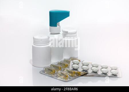 Pillole e vasi con farmaci su sfondo bianco. Isolare. Trattamento con coronavirus. Spazio di copia Foto Stock