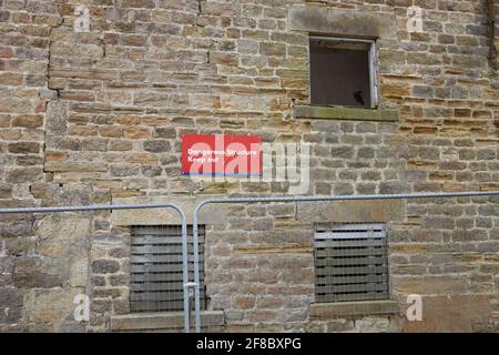 Cartello di avvertenza sul diserelict Round Hill fattoria edificio Foto Stock