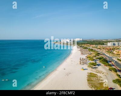 Eagle Beach Aruba, palme sulla costa di Eagle Beach ad Aruba, vista sul drone su una spiaggia con palme e ombrelloni Foto Stock