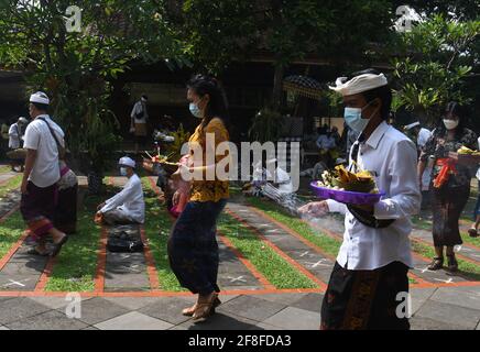 Giacarta, Giacarta, Indonesia. 14 Apr 2021. Gli indù balinesi celebrano la giornata di Galungan con una cerimonia a pura Aditya Jaya, Rawamangun, Giacarta, il 14 aprile 2021. Galungan Day è un giorno in cui gli Indù commemorano la creazione dell'universo e tutti i suoi contenuti e grazie, gli Indù danno e fanno offerte a Sang Hyang Widhi e Dewa Bhatara, come il giorno della vittoria per Dharma (verità) contro Adharma Credit: Dasril Roszandi/ZUMA Wire/Alamy Live News Foto Stock