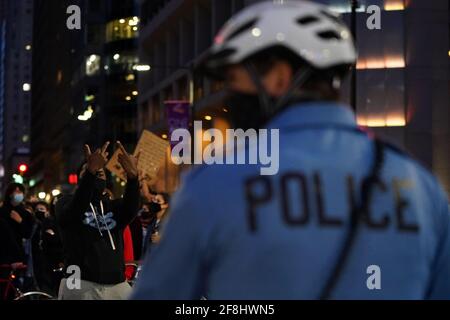 Philadelphia, Stati Uniti. 13 Apr 2021. Un dimostratore ha condotto verso una linea di funzionari della polizia di Philadelphia durante una protesta di Justice for Daunte Wright a Philadelphia, USA. Daunte Wright era un uomo nero di 20 anni che fu ucciso e ucciso da un agente di polizia a Brooklyn Center, Minnesota, il 11 aprile. Credit: Chase Sutton/Alamy Live News Foto Stock