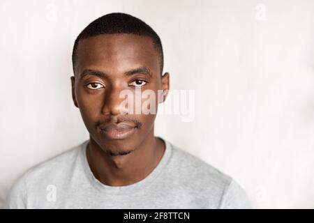 Giovane africano sicuro che indossa una t-shirt Foto Stock