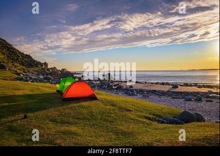 Campeggio al tramonto con tende sulla spiaggia di Utttakleiv nelle isole Lofoten, Norvegia Foto Stock