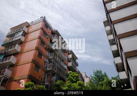 Tipico edificio di appartamenti a più piani in un'area residenziale di Buenos Aires. Alto edificio a più piani in mattoni rossi con balconi Foto Stock