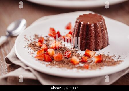 Budino di cioccolato con fragole fresche su un piatto. Foto Stock
