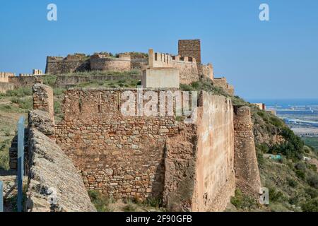 Il castello è una fortificazione difensiva con una lunghezza di quasi un chilometro situata in cima alla collina che protegge la città di Sagunto, Spagna Foto Stock