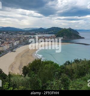 San Sebastian, Spagna - 19 febbraio 2021: Tramonto su Monte Urgull dalla spiaggia di Zurriola Foto Stock