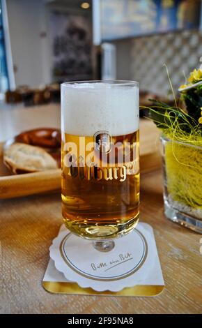 Bitburg, Germania: La Birreria di Bitburger (Bitburger Brauerei) è una grande fabbrica di birra tedesca. Birra Bitburger, bicchiere, montagne russe, con il motto "Bitte ein bit!" Foto Stock