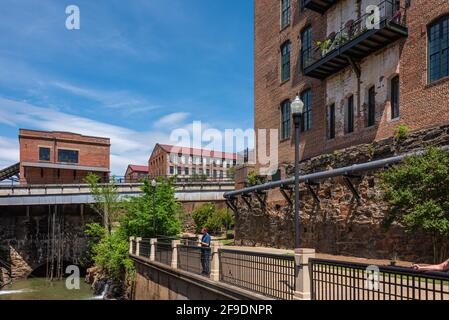 L'uomo pesca nel fiume Chattahoochee dal Columbus Riverwalk dietro l'Eagle & Phenix Mills si trova a Columbus, Georgia. (STATI UNITI) Foto Stock