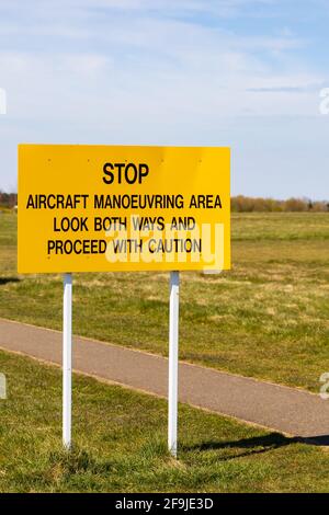 Segnale di avvertimento giallo per campo d'aviazione. Stop. Area di manovra degli aeromobili. Osservare entrambe le direzioni e procedere con cautela Foto Stock