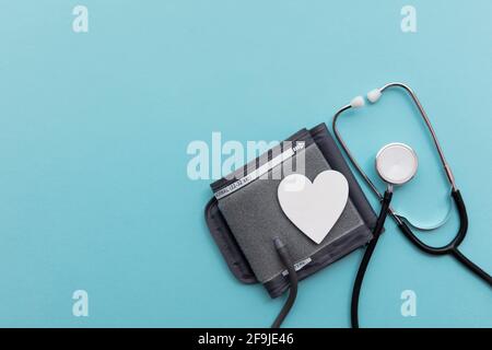Monitor per analisi della pressione sanguigna con uno stetoscopio su un blu sfondo Foto Stock