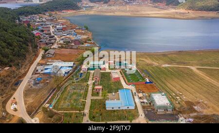 (210419) -- NINGLANG, 19 aprile 2021 (Xinhua) -- Foto aerea scattata il 17 aprile 2021 mostra l'impianto di trattamento delle acque reflue di Zhudi di Lugu Lake nella città di Yongning, nella contea autonoma di Ninglang Yi, nella provincia di Yunnan, nella Cina sudoccidentale. Confinante con la provincia del Sichuan, il Lugu è il lago più alto dello Yunnan, che si erge a circa 2,700 metri sul livello del mare e circondato da montagne ricoperti di foresta. Conosciuto come la "perla scintillante incastonata nell'altopiano", il lago Lugu svolge un ruolo chiave nell'equilibrio dell'ambiente locale. Il lago di Lugu ha visto migliorare la qualità dell'acqua negli ultimi anni in mezzo a continui sforzi di restauro ecologico Foto Stock