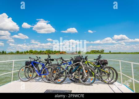 ILMITZ, 17 GIUGNO 2016: Gruppo di biciclette viene trasportato su un ponte di un traghetto tra Ilmitz e Morbisch sul lago di Neusiedlersee in Austria. Foto Stock