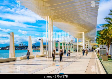 MALAGA, SPAGNA, 4 GENNAIO 2016: La gente sta camminando sulla passeggiata paseo del muelle dos nella città spagnola di malaga che si estende attraverso il porto sotto a c Foto Stock