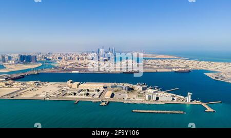 Vista aerea dello skyline di Abu Dhabi che si erge sul mare Formare il moderno lungomare della capitale degli Emirati Arabi Uniti all'alba Foto Stock