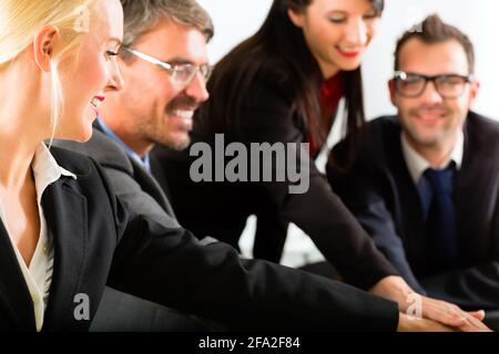 Business - gli imprenditori si riunione del team o di un workshop in un ufficio e unire le mani, è una molto buona squadra Foto Stock