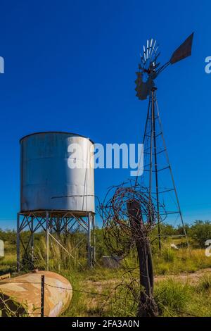 Il mulino a vento e il serbatoio d'acqua forniscono la fonte d'acqua per l'area di Ranch House dell'Empire Ranch e la Las Cienegas National Conservation Area in Arizona, USA Foto Stock