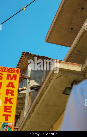 Vasiliki, Grecia - Luglio 24 2019: Architettura di Vasiliki, ristoranti, auto di scuola superiore, mercati con persone a piedi Foto Stock