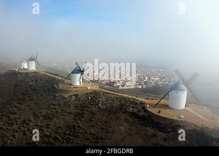 Spagna, Provincia di Toledo, Consuegra, veduta aerea di mulini a vento storici con la città sullo sfondo Foto Stock