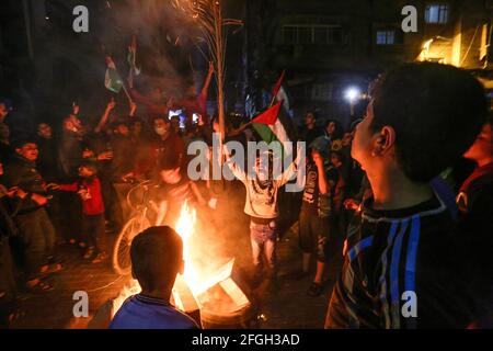 Gaza, Palestina. 24 Apr 2021. I palestinesi cantano slogan mentre bruciano le gomme durante un rally a sostegno della moschea al-Aqsa nella città di Gaza. I palestinesi hanno infuriato ieri sera a Gerusalemme occupata per l'undicesima notte di fila in protesta contro la polizia israeliana e le provocazioni e gli assalti dei coloni ai residenti della città, e si sono espansi per raggiungere la Cisgiordania e la striscia di Gaza. Credit: SOPA Images Limited/Alamy Live News Foto Stock