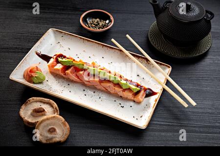 Tataki di salmone tipico cibo giapponese su sfondo scuro. Foto Stock