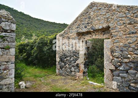 Antica casa rurale abbandonata rovine di pietra a Poulithra, un villaggio tradizionale di Arcadia nel Peloponneso, Grecia. Foto Stock