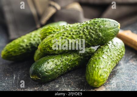 Cetrioli verdi freschi su tavolo da cucina nero. Foto Stock