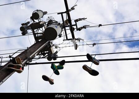 Le scarpe da running si stancarono dalle linee elettriche all'esterno di un negozio di scarpe da running a Raleigh, North Carolina. Foto Stock