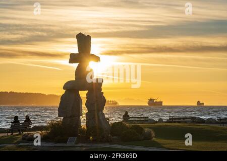 Scultura in pietra Inukshuk al tramonto a English Bay Beach, Vancouver City bellissimo paesaggio. British Columbia, Canada. Foto Stock