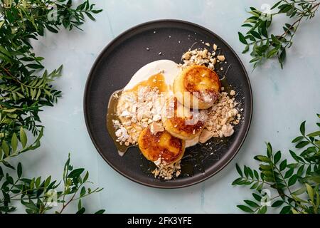 Frittelle al curdo con caramello salato e yogurt Foto Stock