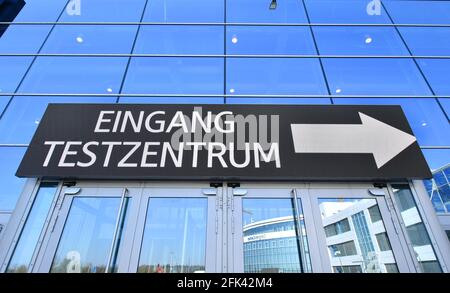 Erfurt, Germania. 28 Apr 2021. L'ingresso al Corona Test Center alla fiera. Il centro di test rapido è gestito principalmente per i visitatori del Federal Horticultural Show nella sala espositiva 3. È prevista una capacità di test di 5,000 persone al giorno e a tale scopo sono state allestite 20 stazioni. Il centro è aperto al pubblico dal lunedì alla domenica dalle 7:30 alle 20:30. Credit: Martin Schutt/dpa-Zentralbild/dpa/Alamy Live News Foto Stock