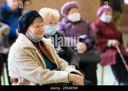 Meeting Club degli anziani. Un gruppo di persone anziane che indossano maschere mediche durante una riunione o in un'infermiera h Foto Stock