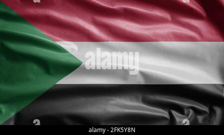Bandiera sudanese che oscilla nel vento. Primo piano di Sudan banner soffiante, morbida e liscia seta. Tessuto tessuto tessuto tessitura segno sfondo. Usalo a livello nazionale Foto Stock