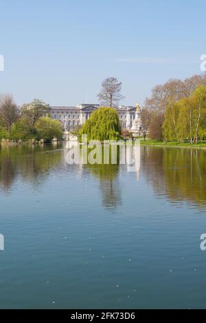Buckingham Palace e il monumento Victoria Memorial, visto dal Blue Bridge che attraversa il lago ornamentale di St James's Park Londra, Inghilterra, Regno Unito Foto Stock