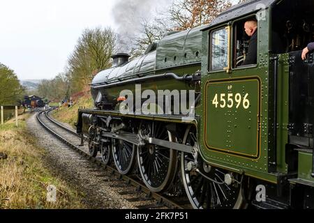 Storico treno a vapore loco su binari che soffia fumo, viaggiando sulla ferrovia storica (uomo sul piatto e numero sul lato) - KWVR, Yorkshire Inghilterra UK. Foto Stock