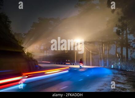 La vista notturna della strada di passaggio è scritta in Vietnamita "nebbia" con magici semafori e traffico sentieri che rendono la notte più bella Foto Stock