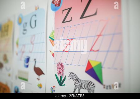 Immagine della profondità di campo poco profonda (fuoco selettivo) con lettere, animali e simboli sulla parete di una scuola elementare Foto Stock