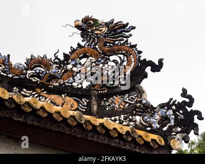 Hue, Vietnam - 11 marzo 2016: Scultura di drago scolpito sul tetto di un padiglione nella città imperiale di Hue Foto Stock