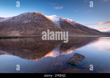 Le montagne innevate delle Highlands si riflettono nelle acque calme di Loch Etive in inverno, Highlands, Scozia, Regno Unito, Europa Foto Stock