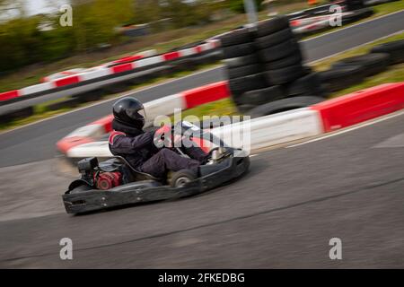 Un'immagine panoramica di un kart da corsa mentre si guida su una pista. Foto Stock