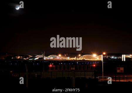 TAG Aviation hangar all'aeroporto di Farnborough di notte, con hangar, jet privati, jet business, business commerciale, torre di controllo del traffico aereo Foto Stock